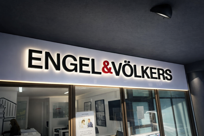 Illuminated storefront fascia signage installed on a retail shopfront